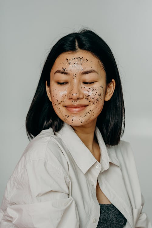 A Woman in White Top Smiling with Glitters on Her Face