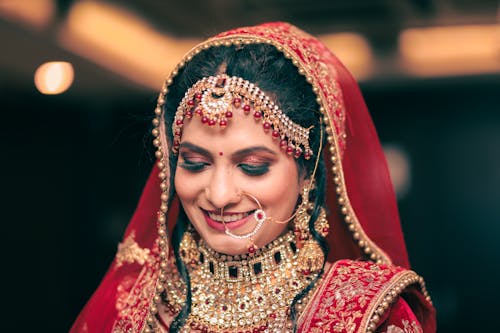 A Beautiful Woman Smiling while Wearing Maang Tikka