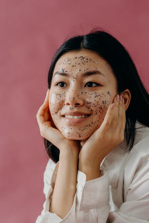 A Smiling Woman with Glitters on His Face