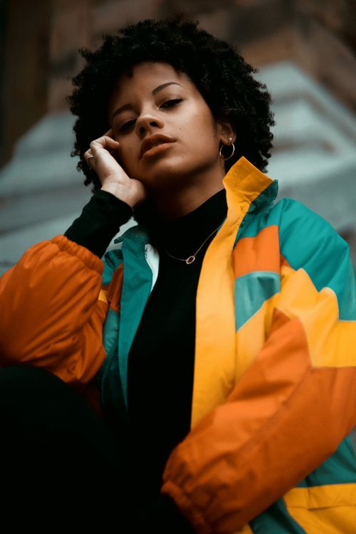 Free Stylish African American woman poses in a colorful jacket in Montreal. Stock Photo