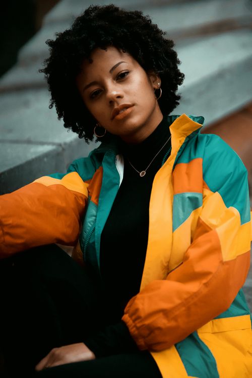 Free Portrait of a woman in a vibrant jacket posing outdoors in Montreal. Stock Photo
