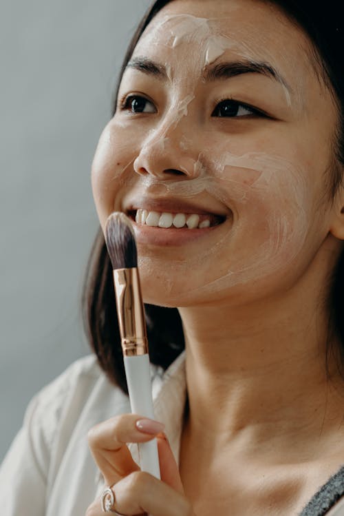 A Smiling Woman with a Cream on Her Face