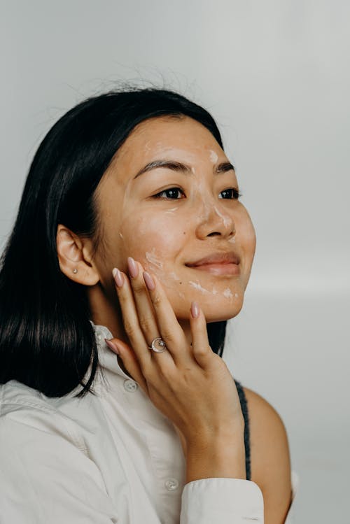 Free A Woman Touching Her Face Stock Photo