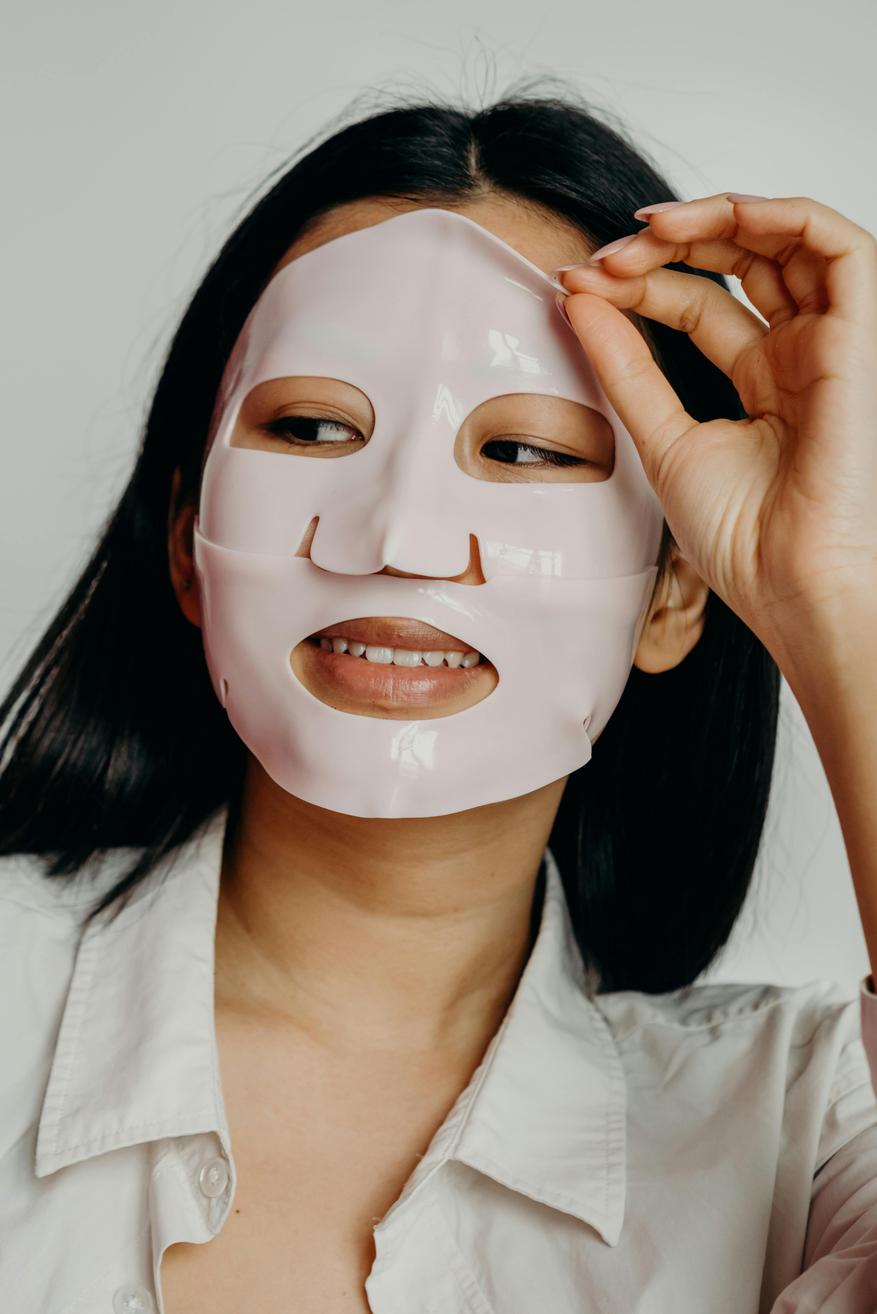 a woman peeling her facial mask