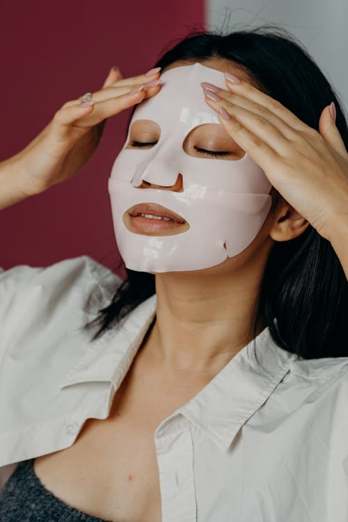 A Woman Touching Her Face with Mask with Her Eyes Closed