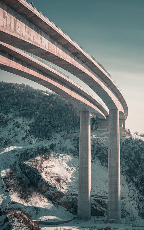 Free Landscape Photography of a Bridge by a Mountainside Stock Photo