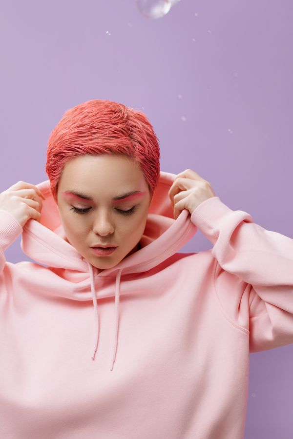 Woman in a pink hoodie with black leggings