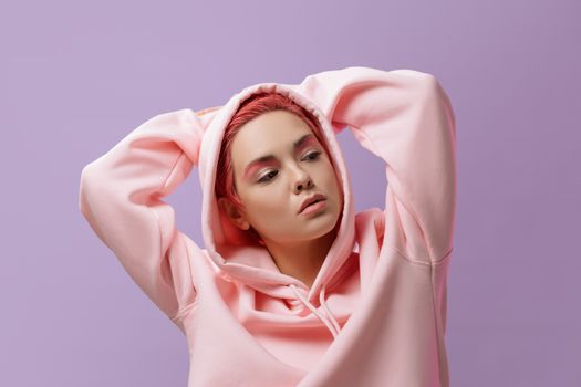 A Woman Modeling in a Pink Hoodie