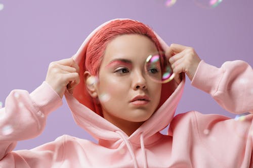 A Woman in Hoodie Jacket with Bubbles in Front