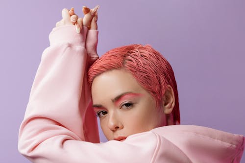 Model With Dyed Pink Hair Wearing a Pink Hoodie