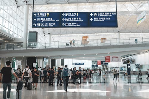 People Walking in the Main Terminal Hall in Chek Lap Kok Hong Kong Airport