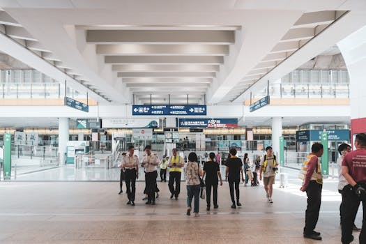 People walking within the modern transportation hub in New Territories, Hong Kong.
