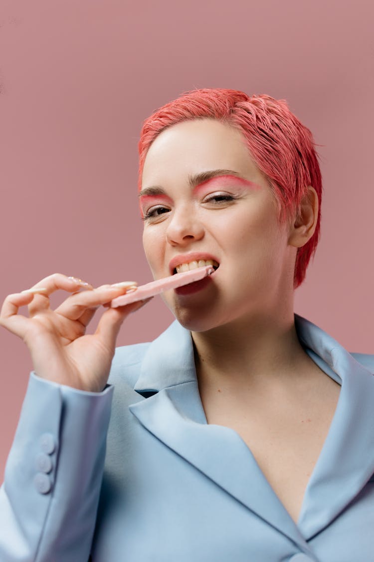 A Woman Eating A Sweet Food 