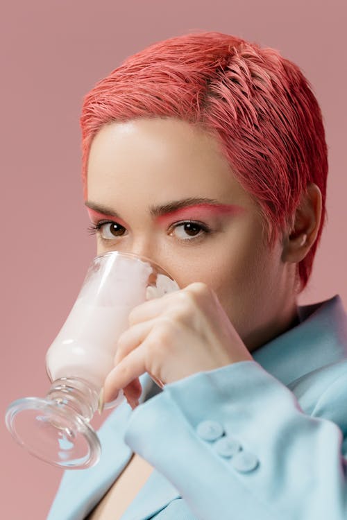 Portrait of Woman with Pink Hair Drinking from Cup