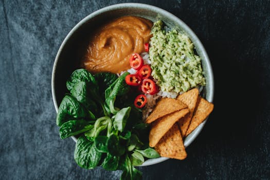 Delicious vegan bowl featuring avocado, rice, and fresh greens perfect for a healthy meal.