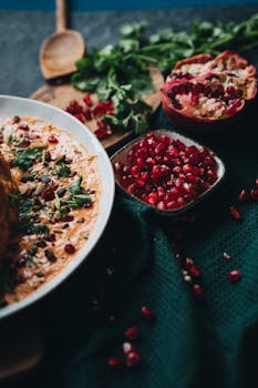 A deliciously styled vegan dish topped with vibrant pomegranate seeds, perfect for healthy meal inspiration.