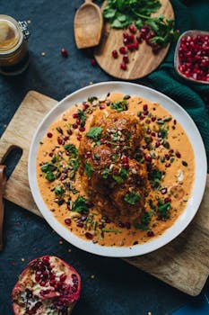 Delicious roasted cauliflower with vibrant garnet sauce and garnished with herbs, perfect for a healthy vegan meal.