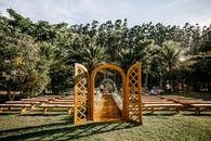 Wedding arch and guest benches placed in verdant park