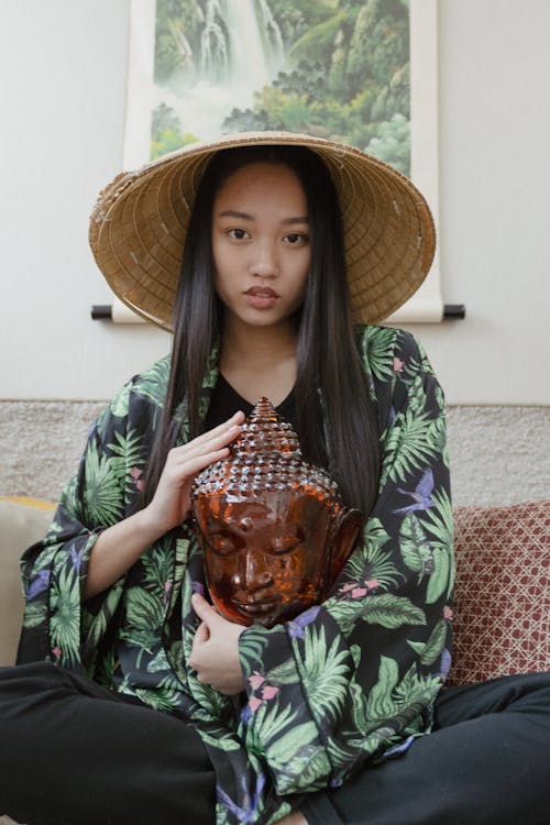 A Woman in Printed Robe Wearing a Conical Straw Hat