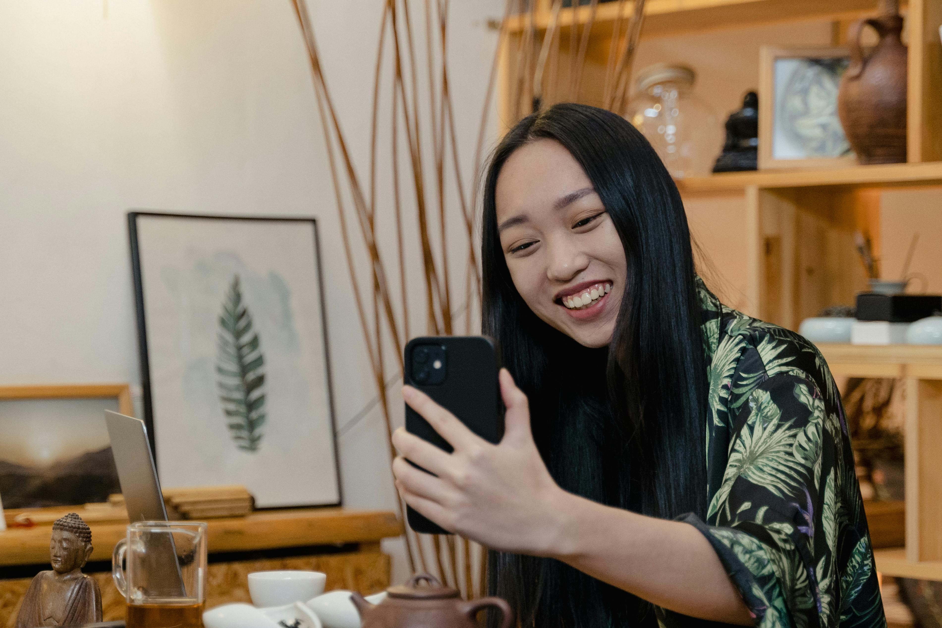 a woman smiling while having a video call