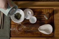 Tea Ceremony with White Ceramic Tea Set on Wooden Board