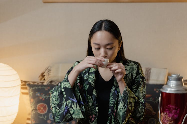 A Woman Drinking Tea In A Tea Bowl