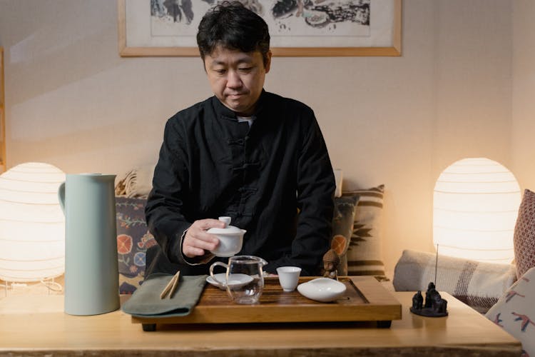 Man Holding Tea Ceremony In A Room