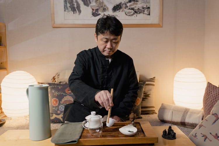 Man Holding Tea Ceremony In A Room