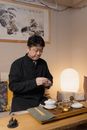 Man Holding Tea Ceremony in a Tea Room