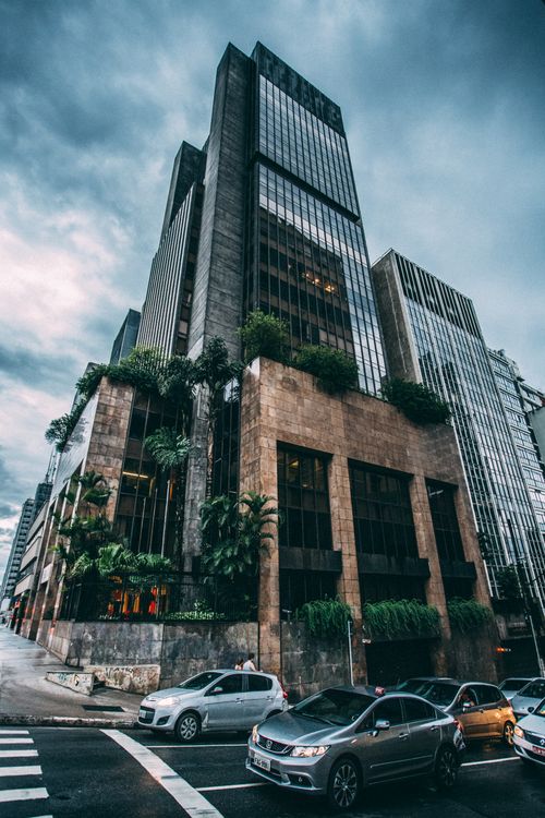 Free Gloomy city street view featuring tall modern buildings and traffic. Stock Photo