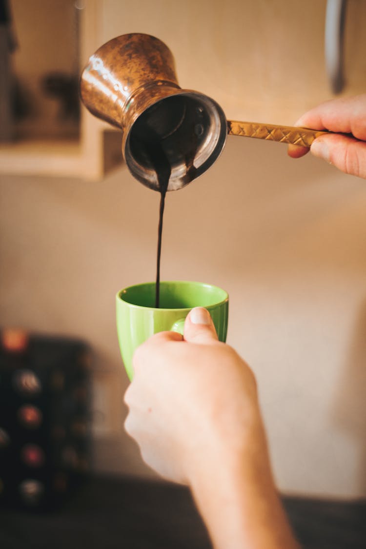 Crop Person Pouring Coffee In Cup