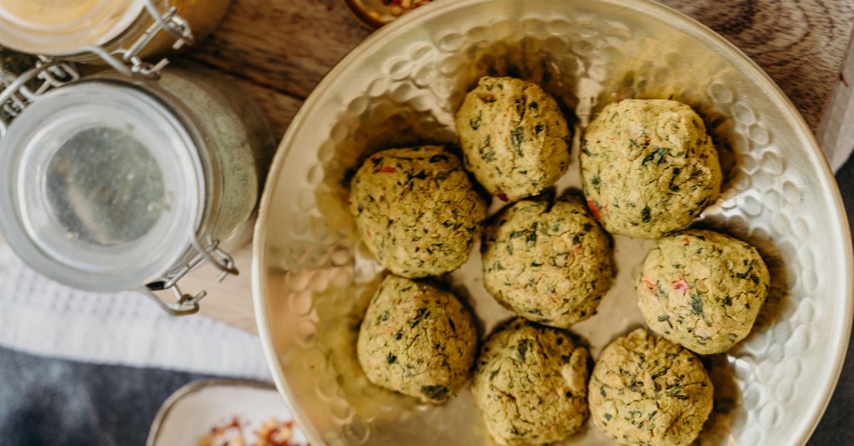 air fryer basket filled with crispy canned chickpeas and fresh herbs