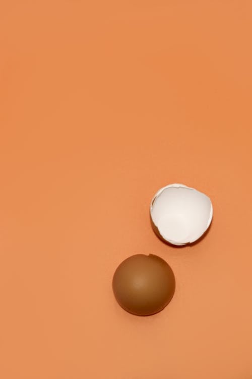 Free White Egg on Orange Surface Stock Photo