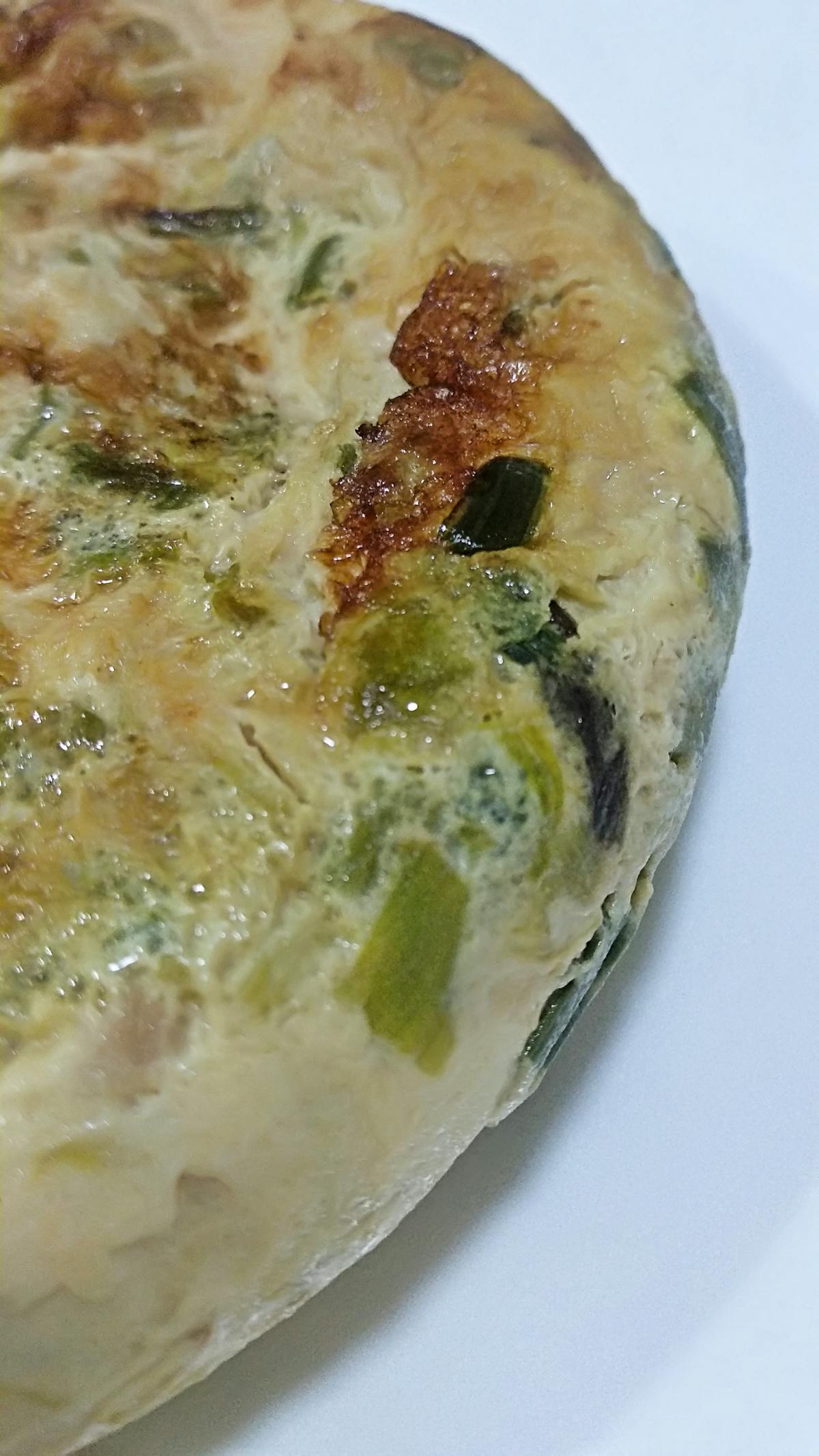 Person preparing a plant-based bowl with tofu and vegetables