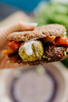 Close-up of a vegan falafel sandwich with fresh veggies, perfect for a healthy meal.