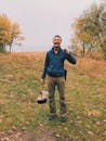 Happy man with metal pot in nature