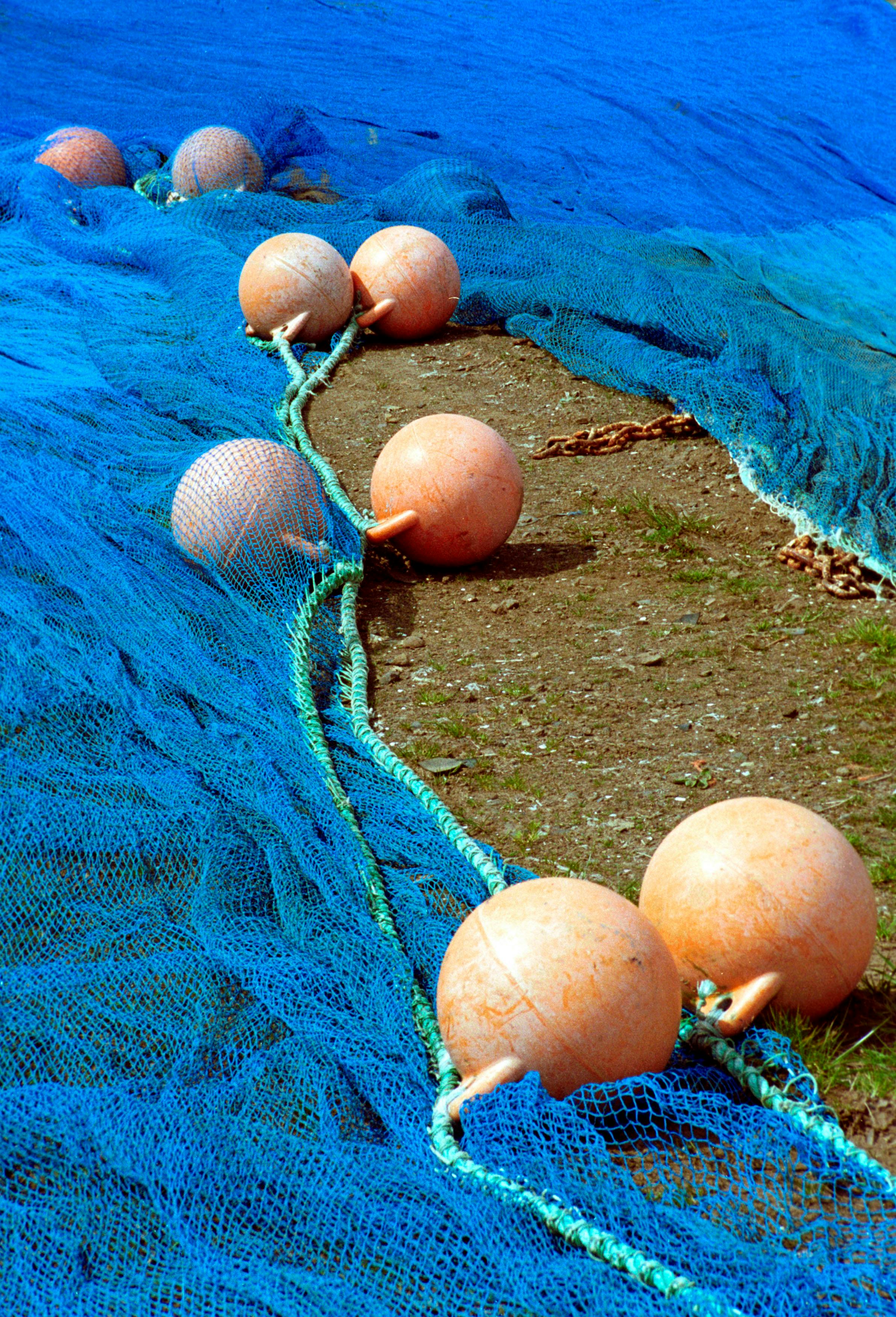 Fishing net with ropes and floats is drying on the pier, close-up,  selective focus 17028159 Stock Photo at Vecteezy