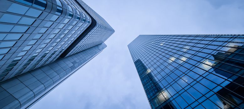Low angle view of modern skyscrapers in Frankfurt, showcasing urban architecture.