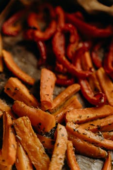 Delicious roasted carrots and bell peppers seasoned with herbs. Perfect for healthy vegetarian meals.