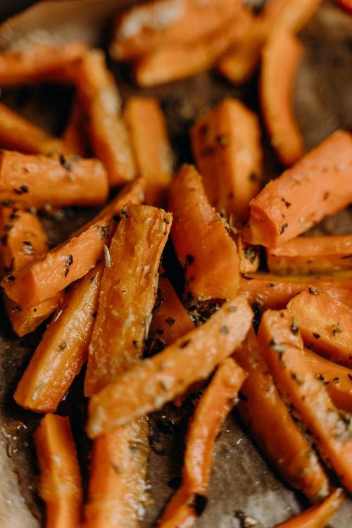 Free Close-up of seasoned roasted carrot sticks showcasing delicious, healthy food. Stock Photo