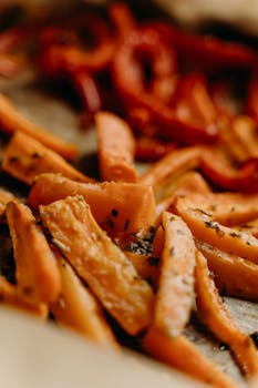 Delicious roasted carrots and peppers seasoned with herbs, perfect for a healthy, vegan meal.