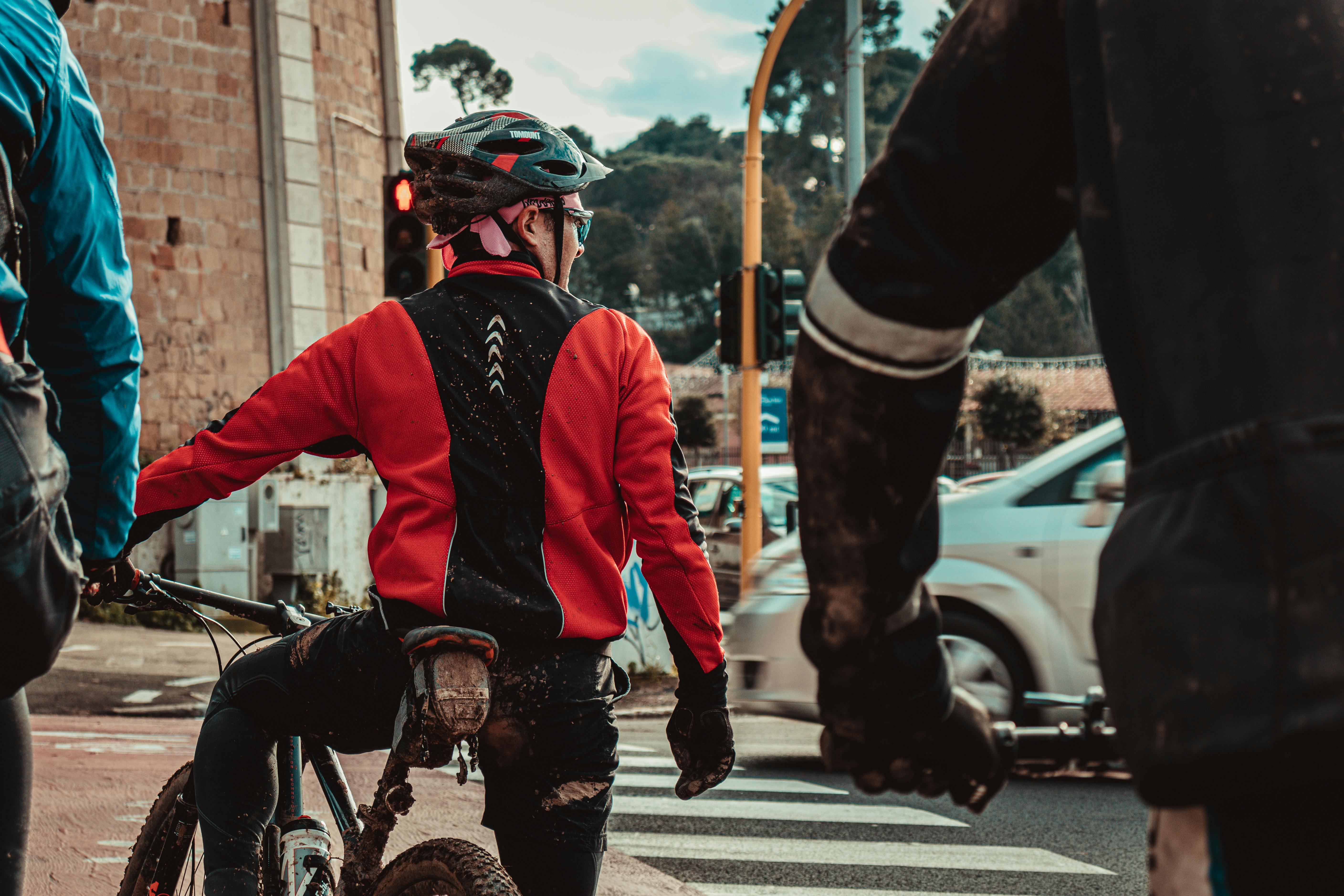 A Man Wearing a Helmet while Riding a Bicycle · Free Stock Photo