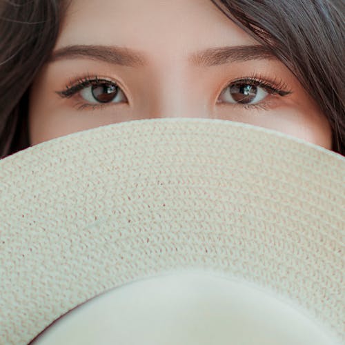 Free Person Covering Face With Hat Photo Stock Photo