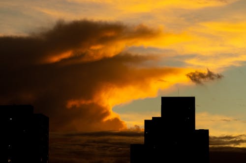 Cloudy sunset sky over building