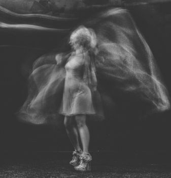 Abstract black and white image of a woman dancing, capturing motion and expression.