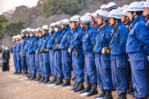 Free People in Blue Uniform Stanidng on a Row  Stock Photo