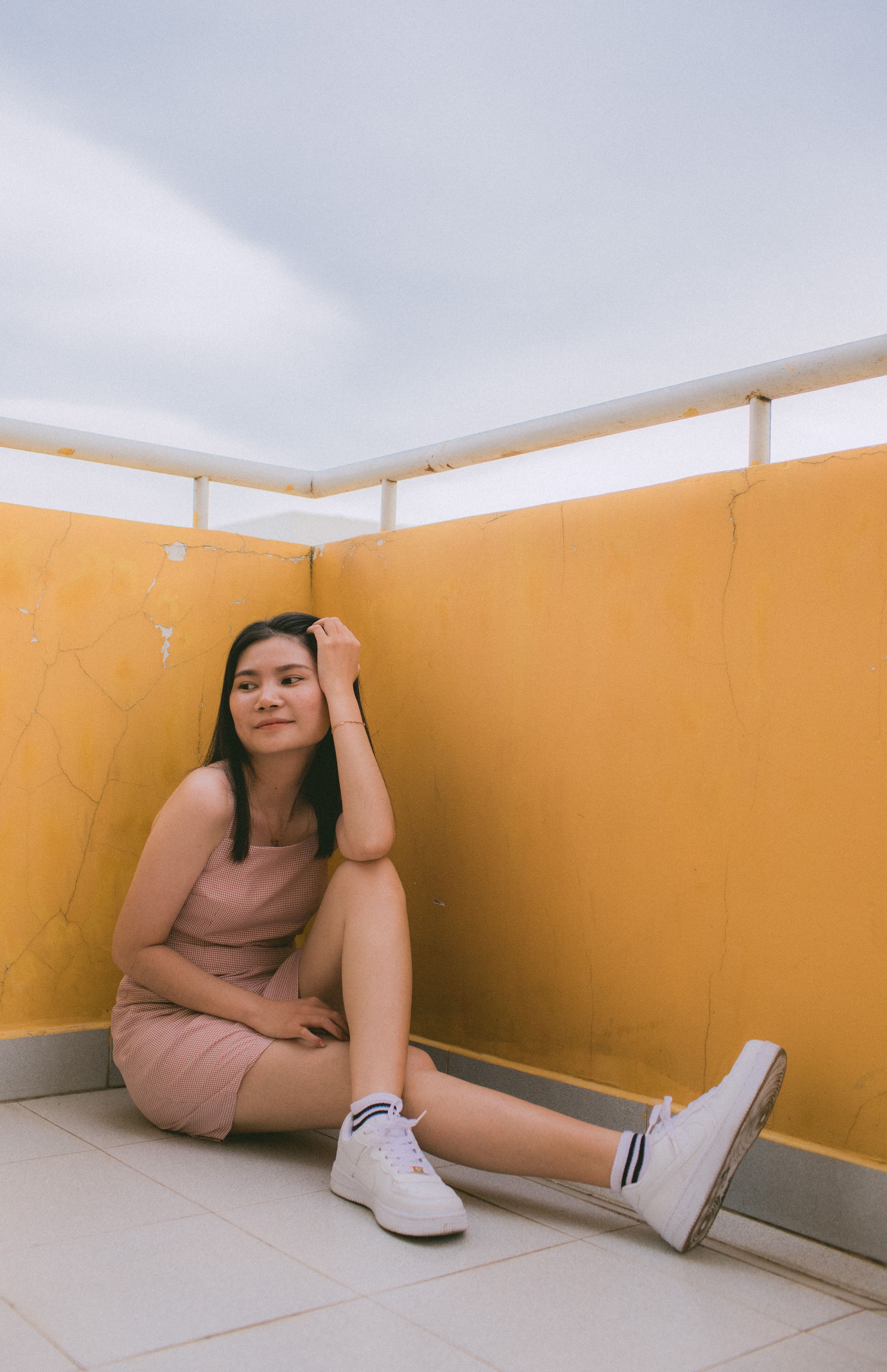 Woman in White Long Sleeve Dress Sitting on the Ground · Free Stock Photo