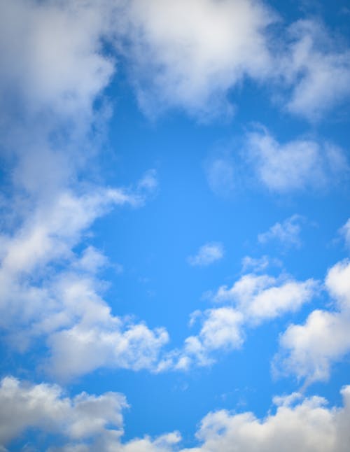 Fluffy clouds floating in blue sky