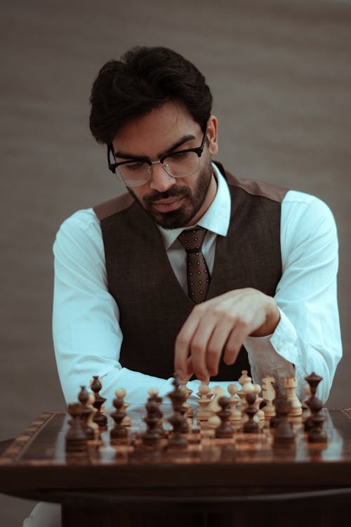Free Thoughtful man playing chess during competition Stock Photo