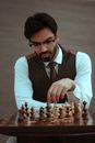 Thoughtful man playing chess during competition